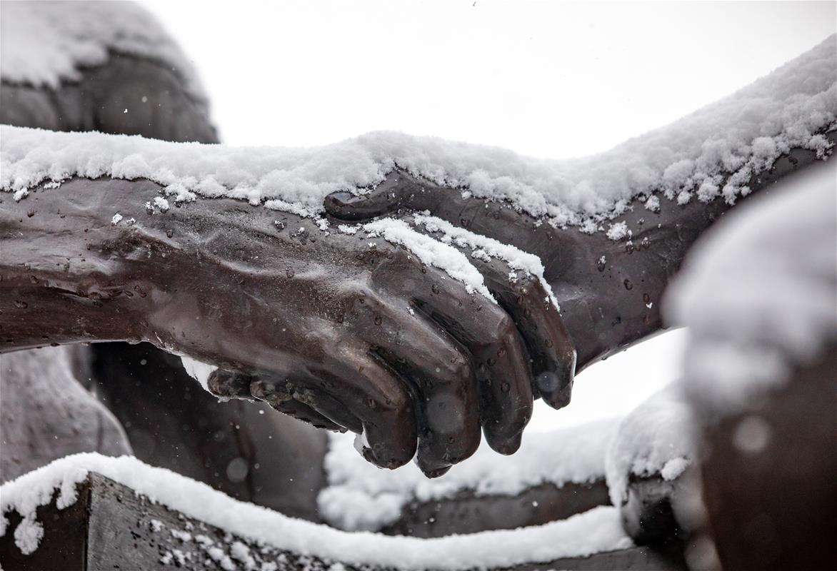 Snow blankets the campus at the University of Illinois Champaign-Urbana. Alma Mater, the beloved bronze mother figure that has greeted generations of University of Illinois students, graces the entry way to the campus.